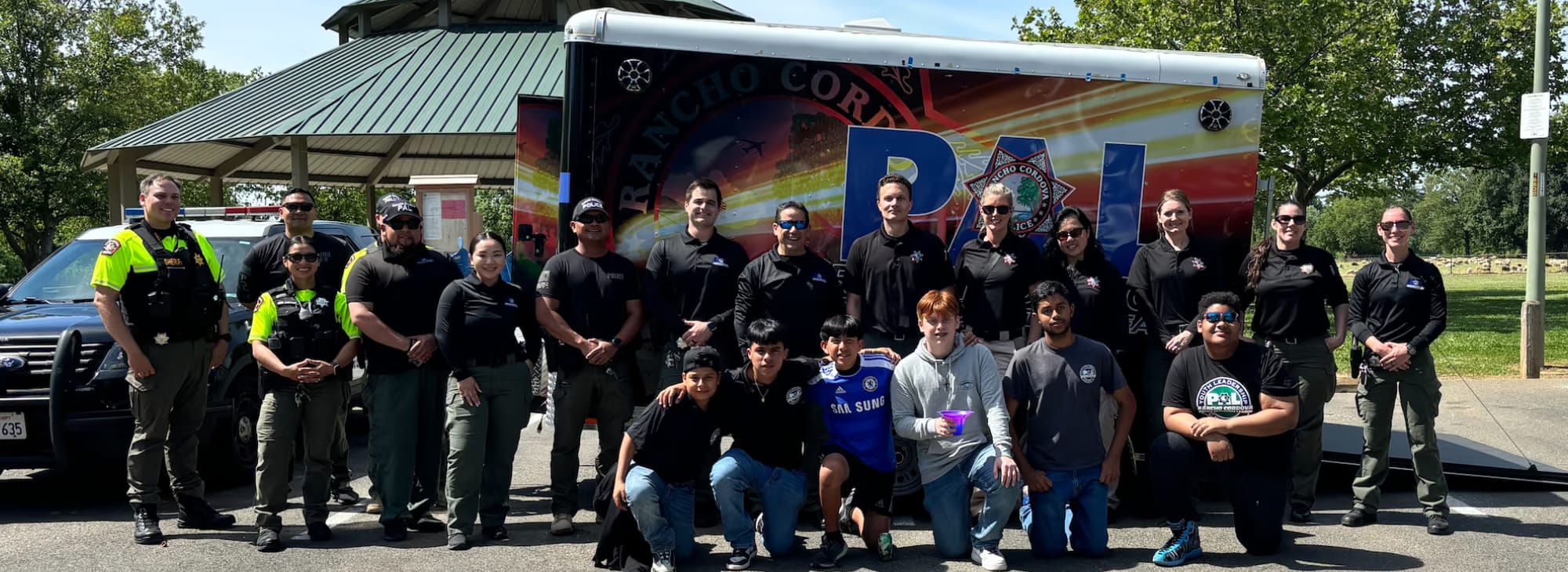 RCPD PAL program participants, staff, and local law-enforcement partners gathered at a public community event