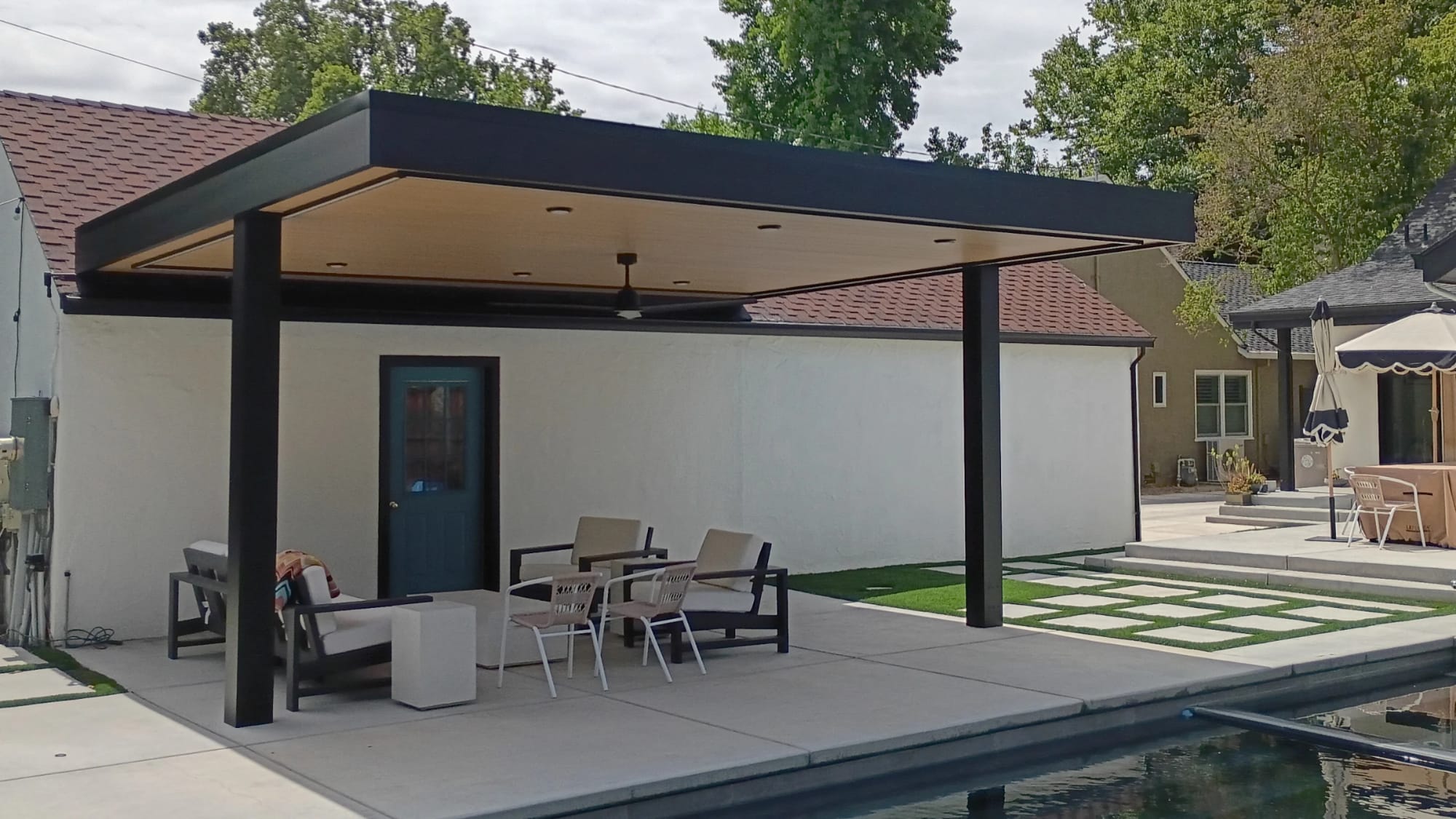 A completed Goodwin-Cole pergola installation beside a residential pool